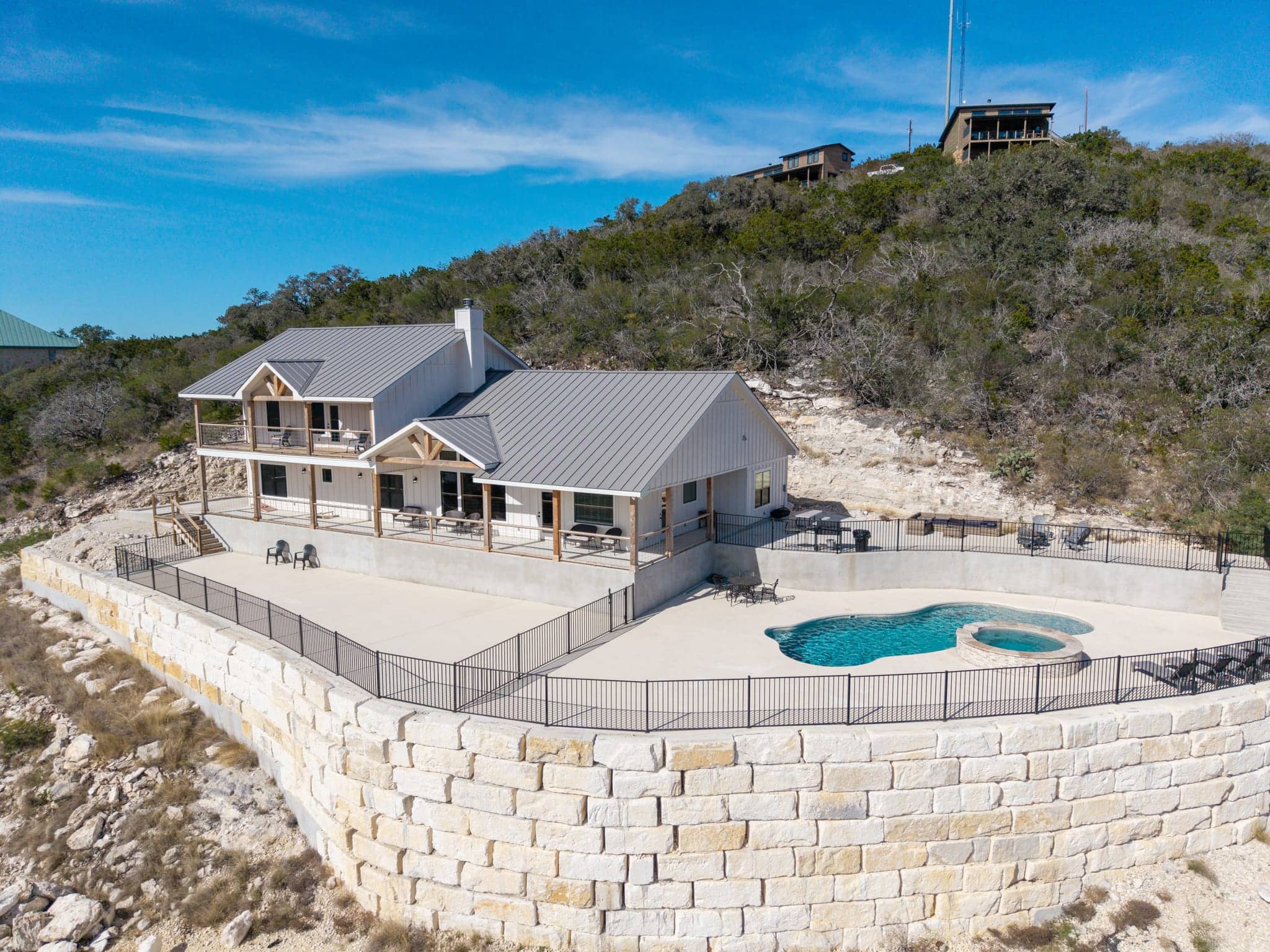 Aerial view of a secluded Hill Country estate and pool