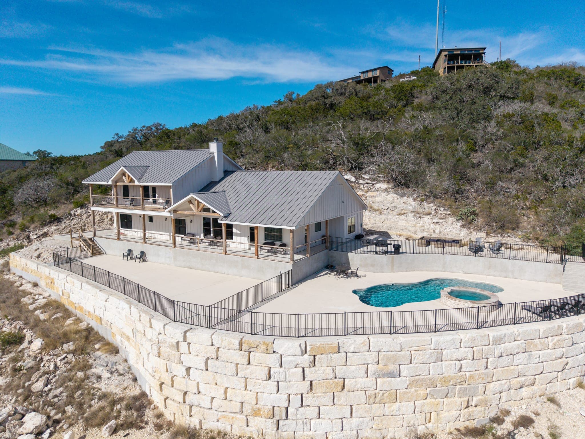 Aerial view of a secluded Hill Country estate and pool