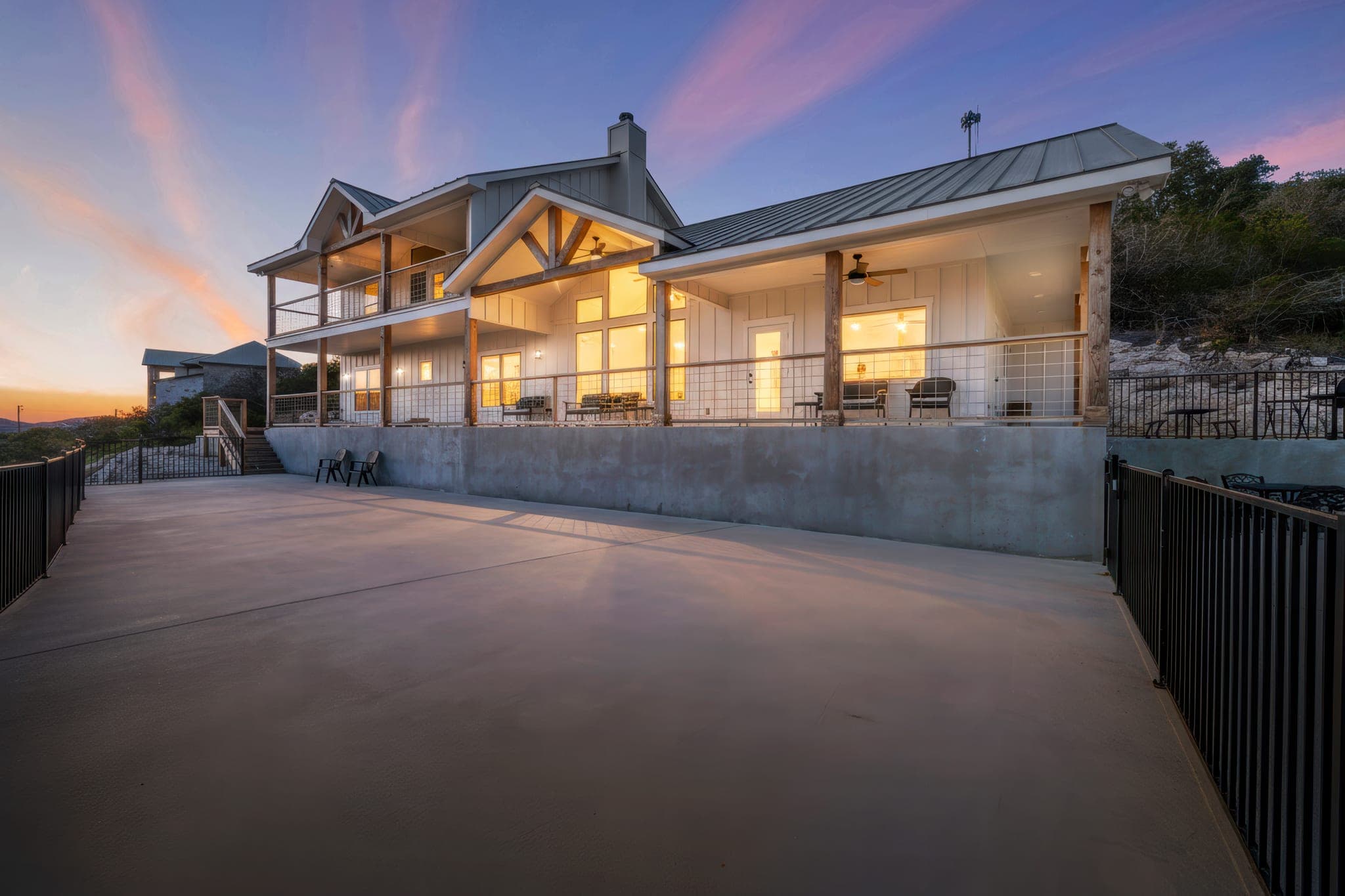 Hill Country home exterior glowing at twilight