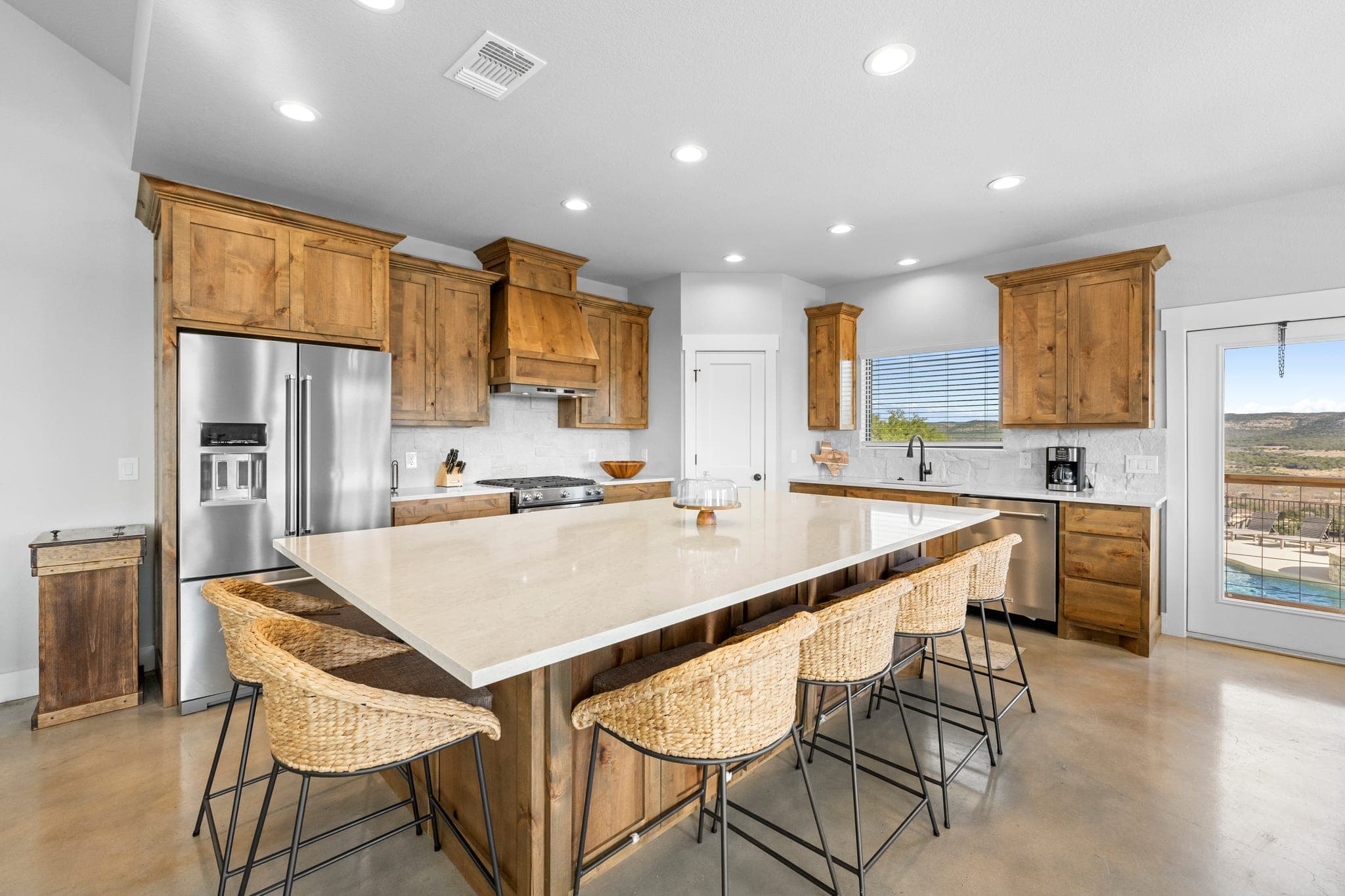 Open kitchen with a large island and Hill Country views