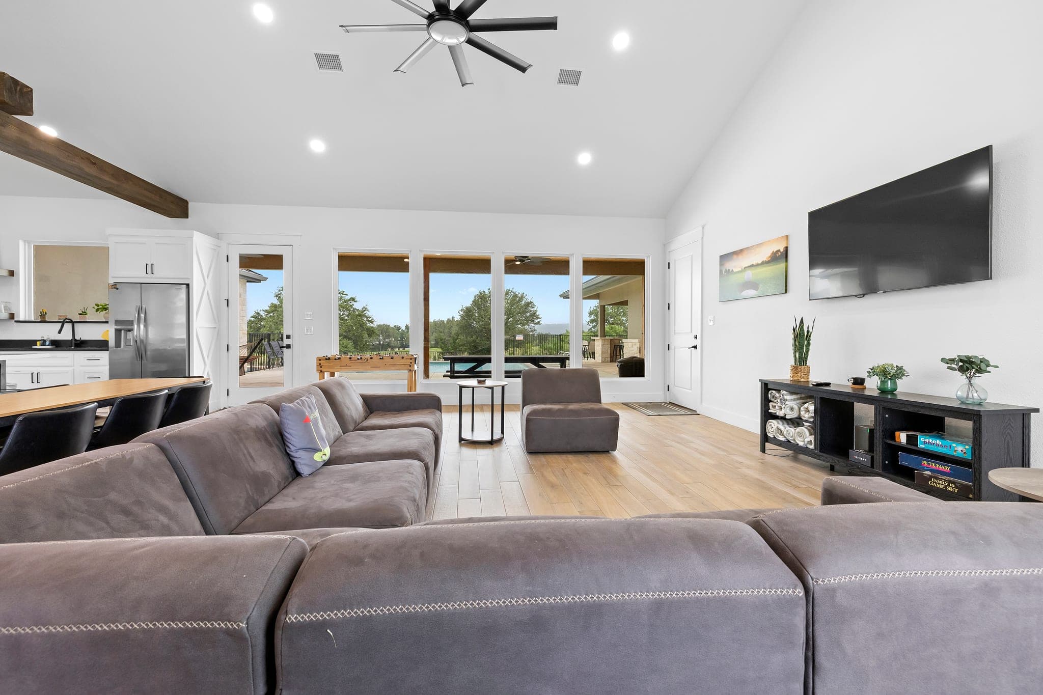 Modern open-concept living room with exposed ceiling beams