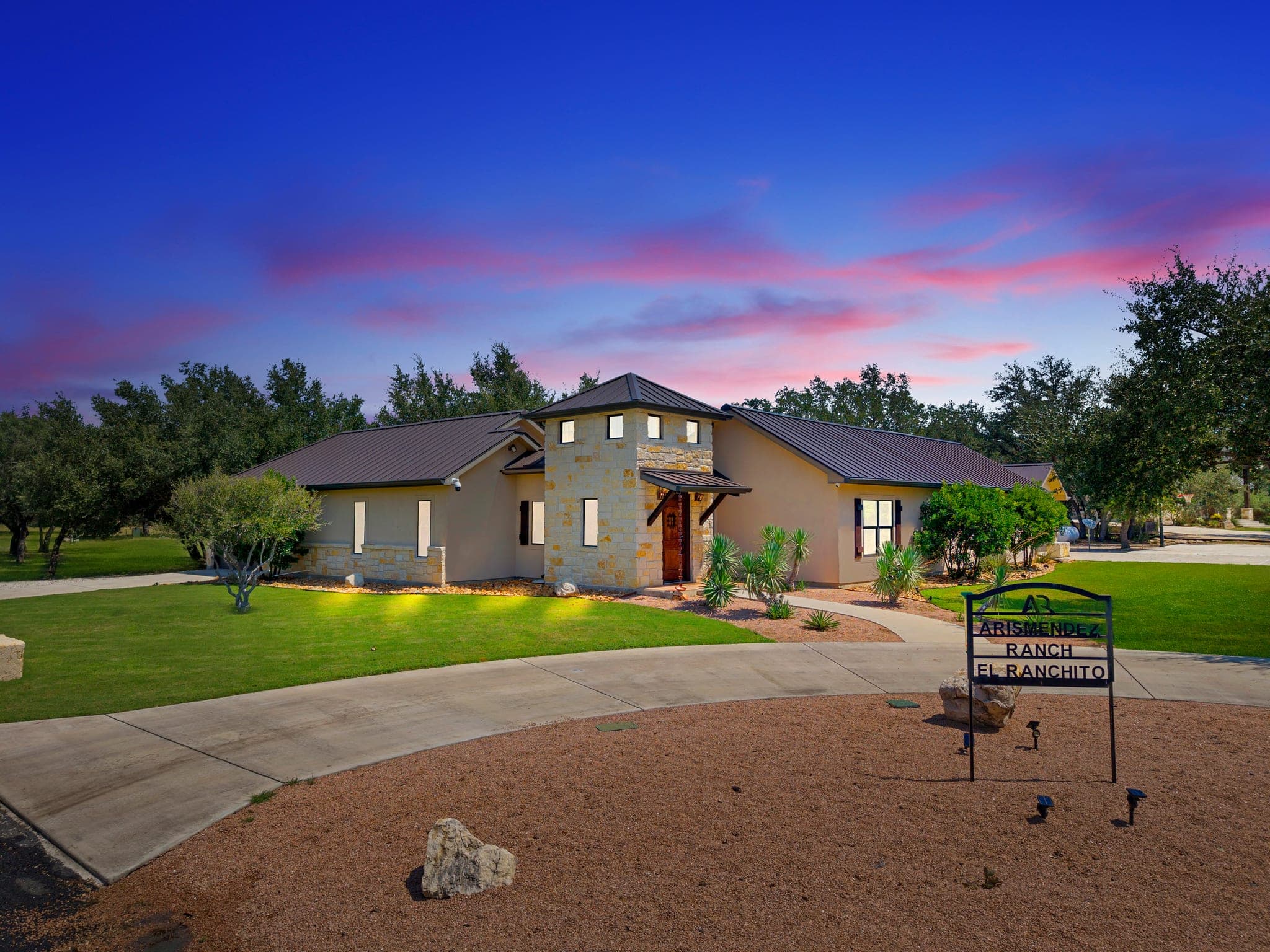 Ranch-style property photographed under a vivid twilight sky
